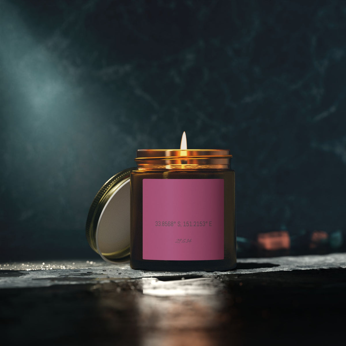 Amber jar candle with your coordinates on a dark table